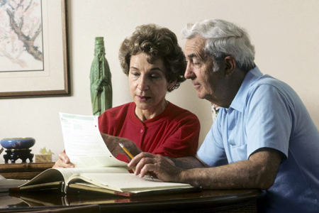 Retired Couple Checking on Financial Records